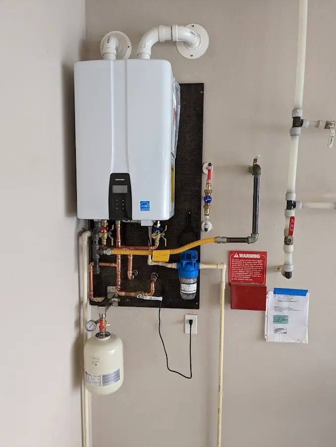 Professional plumber installing copper piping in a Highland home